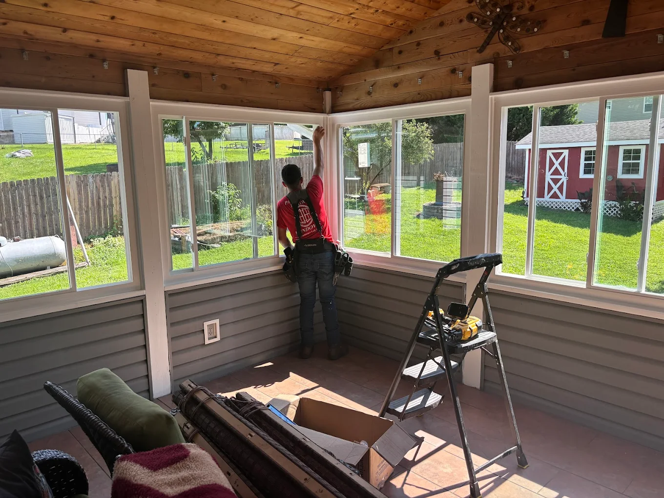 Installer finishing enclosed porch windows